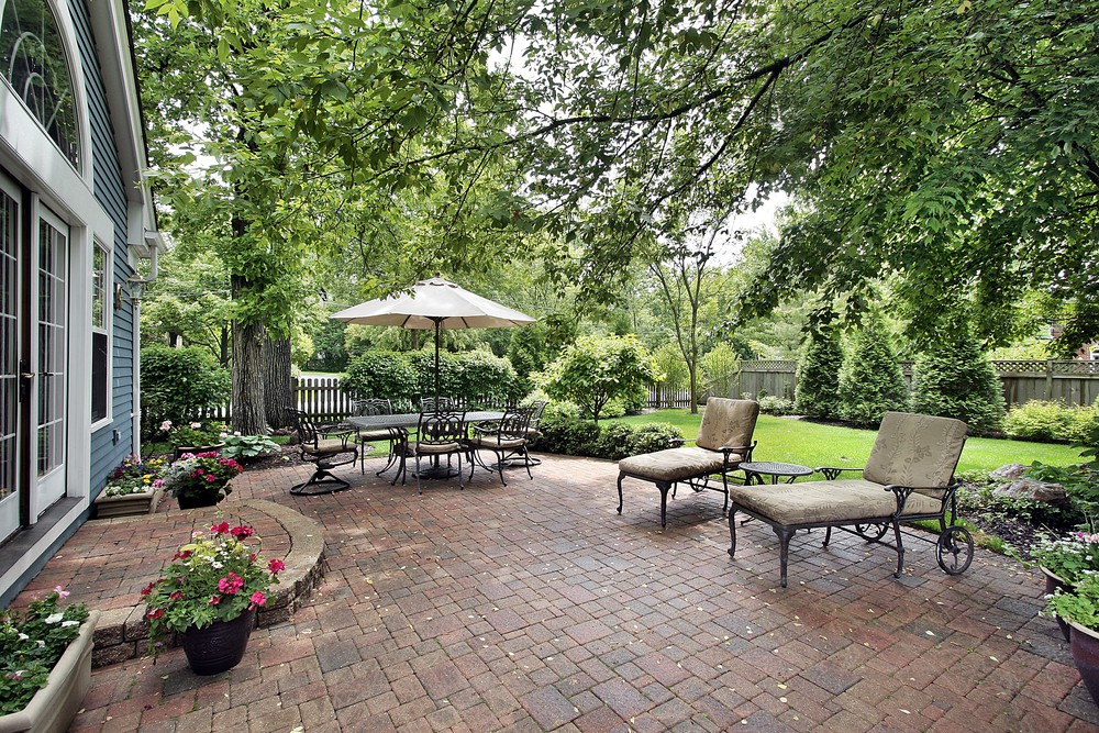 Brick patio with table umbrella and chairs